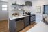 Modern kitchen with sleek appliances, elegant countertops, and stylish open shelving, perfect for culinary creativity.
