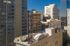 Charming urban rooftops with iconic MUSES sign, set against a backdrop of stylish city skyscrapers. Perfect downtown location for modern living.