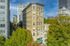 Charming historic building with classic architecture, nestled in an urban setting surrounded by lush greenery and cityscape.