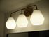 Elegant modern light fixture with three frosted hexagonal shades and a sleek gold finish, adding warmth and style to any room.