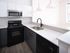 Modern kitchen with sleek black appliances, elegant white cabinetry, and chic pendant lighting, perfect for culinary enthusiasts.