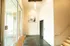 Inviting apartment lobby with modern design, elegant artwork, and natural light streaming through large windows.