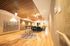 Elegant apartment hallway with stylish wood panel ceiling and cozy seating area, featuring soft lighting and modern decor.