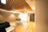 Contemporary apartment living space featuring elegant wooden ceiling accents, sleek furniture, and warm ambient lighting for a cozy atmosphere.