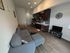 Chic open-plan apartment with a cozy living area, modern kitchen, and elegant wood flooring, perfect for city living.