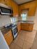 Charming kitchen with modern stainless steel appliances, cozy wood cabinetry, and a sunlit window view.