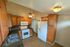 Inviting kitchen with elegant wooden cabinets, modern appliances, and a stylish tile floor creating a warm and functional space.