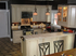 Elegant kitchen with classic cream cabinets, modern appliances, and warm pendant lighting, offering a cozy and inviting atmosphere.