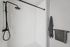 Sleek and modern walk-in shower with elegant black fixtures and soft gray towels for a luxe bathroom experience.