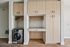 Sleek laundry area with stylish cabinetry and modern washing machine, perfect for contemporary living.