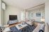 Inviting virtually staged living room with neutral-toned sofas, stylish decor, and a sleek flat-screen TV creating a modern, cozy atmosphere.