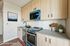 Contemporary kitchen with sleek cabinetry, modern appliances, and stylish decor in a virtually staged setting.