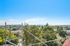 Panoramic view from apartment showing a vibrant urban landscape with lush greenery, perfect for a serene and scenic lifestyle.