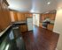 Spacious kitchen with elegant wooden cabinets, sleek granite countertops, and stainless steel appliances, offering a perfect blend of style and functionality.