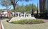Inviting entrance to Terra Apartments, showcasing elegant landscaping and a welcoming stone sign.