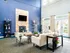 Elegant communal living area with a stone fireplace, modern furniture, and large windows offering ample natural light.