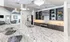Luxurious kitchen with granite countertops, stylish pendant lighting, and modern appliances adjacent to an inviting living area.