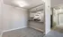 Bright and modern open kitchen with sleek granite countertops, elegant cabinetry, and contemporary light fixtures in a stylish apartment.
