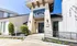 Elegant apartment entrance with a stone facade, modern architecture, and lush landscaping at Terra.