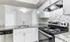 Modern kitchen with sleek granite countertops, stainless steel appliances, and stylish mosaic backsplash, showcasing a bright and inviting space.