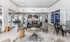 Contemporary open-plan living space with stylish furniture, modern kitchen, and vibrant artwork in a chic apartment.