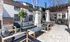 Chic outdoor patio with modern furniture and stylish pergola in a serene apartment setting.