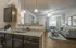 Chic apartment interior featuring a modern kitchen with granite countertops, stylish living area with cozy sofas and contemporary decor, and ample natural light.
