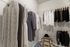 Spacious walk-in closet with elegant clothing and accessories, featuring organized shelves and chic storage space.