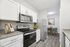 Modern kitchen with sleek granite countertops, stainless steel appliances, and a cozy dining nook.
