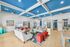 Inviting lounge area with stylish blue ceiling, vibrant artwork, and plush seating perfect for relaxation.