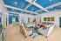 Vibrant and modern lounge area with blue coffered ceiling, colorful seating, and contemporary decor.