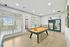 Bright recreation room featuring a modern billiard table, large windows, and elegant wood flooring, perfect for entertaining.