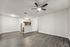 Modern open-concept living area featuring elegant wood flooring and a sleek kitchen with stainless steel appliances.