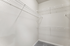 Spacious walk-in closet with sleek white shelving, ideal for organized storage solutions.