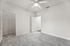 Bright and airy bedroom with soft carpeting, a ceiling fan, and a spacious walk-in closet.
