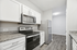 Modern kitchen featuring sleek stainless steel appliances, granite countertops, and elegant white cabinetry.