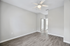 Bright, modern room with sleek hardwood flooring and a ceiling fan, perfect for a fresh living space or cozy bedroom.