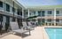 Property exterior with swimming pool and lounge area.