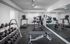 Fitness room with equipment and free weights.