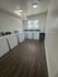 Modern laundry room with multiple washers and bright lighting.