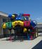 Bright courtyard of an apartment complex with clean architecture and a vibrant playground.