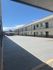 Open and spacious courtyard of a modern apartment complex with a blue sky backdrop.