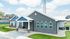 Charming suburban home with modern gray brick fa&ccedil;ade, beautifully landscaped lawn, and inviting entrance.