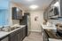 Modern kitchen with sleek stainless steel appliances, rich dark cabinetry, and elegant marble countertops.