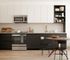 Modern kitchen with sleek cabinetry, stainless steel appliances, and a cozy dining area, ideal for stylish living.
