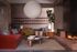Chic living room with modern red sofa, stylish chairs, and a warm fireplace, creating a cozy and inviting atmosphere.