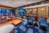 Luxurious open-concept living space featuring modern furniture, vibrant decor, and a sleek dining area perfect for entertaining.
