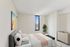 Bright and cozy bedroom with modern decor, featuring a plush bed, abstract art, and a scenic view through a large window.