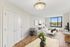 Bright and inviting living room with elegant decor, large window offering scenic views, and a cozy seating area perfect for relaxation.