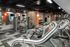 Modern fitness center with state-of-the-art exercise equipment, including treadmills, weight machines, and a bright, inviting atmosphere.